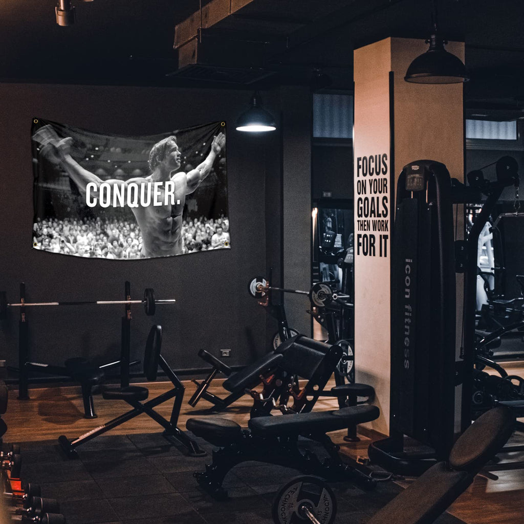 Arnold Schwarzenegger Conquer Motivational Inspirational Office Gym Wall Decor Flag Banner，3x5 Feet Flag Funny Poster Durable Man Cave Wall Flag with Brass Grommets This beautiful entertaining banner flag for College Dorm Room Decor,Outdoor,Parties gifts